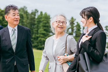 An elderly man, a woman, and a young woman